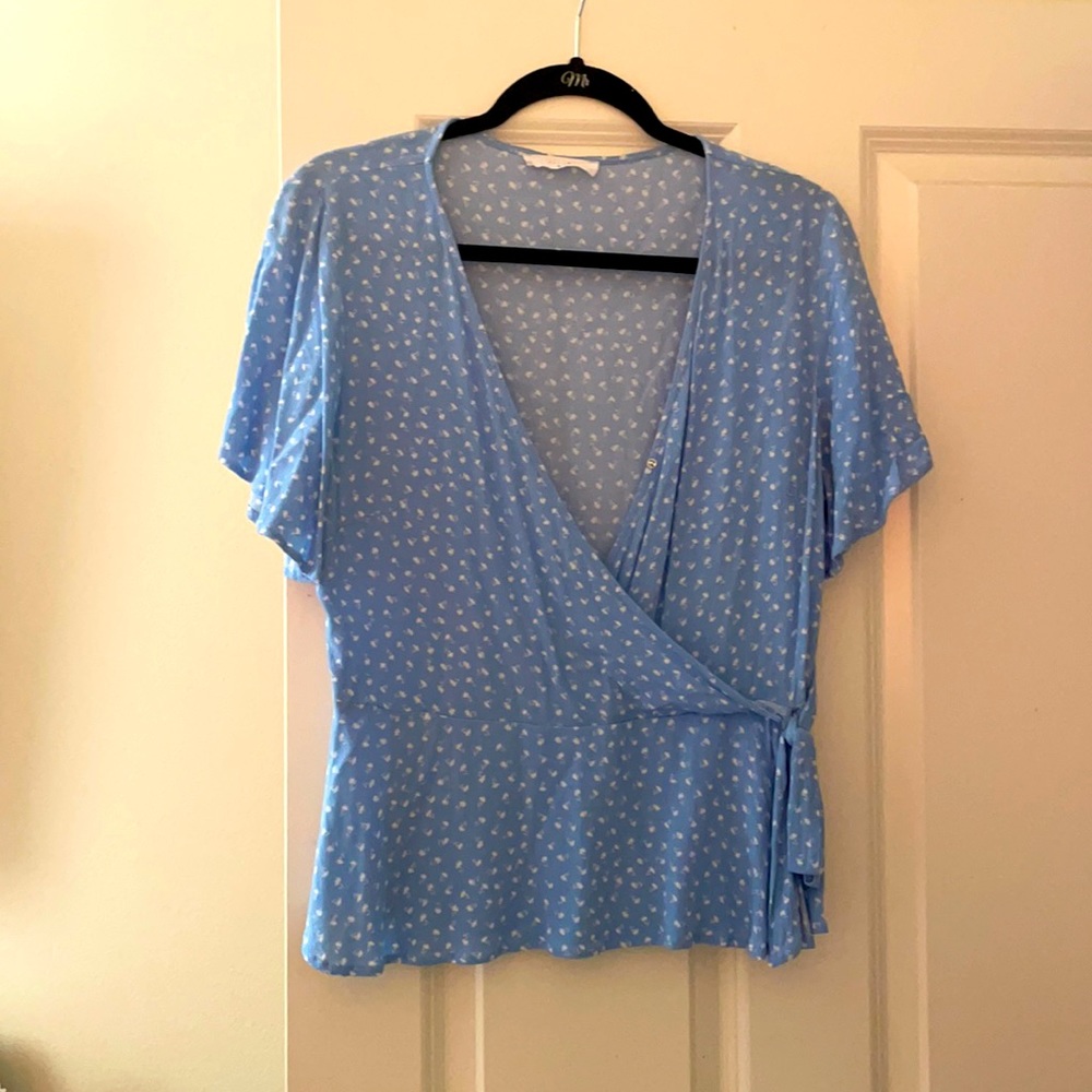 Women’s Elodie faux wrap top. Baby blue in color with white print.
